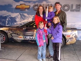 Nosack family holding an Olympic torch at the Chevy booth